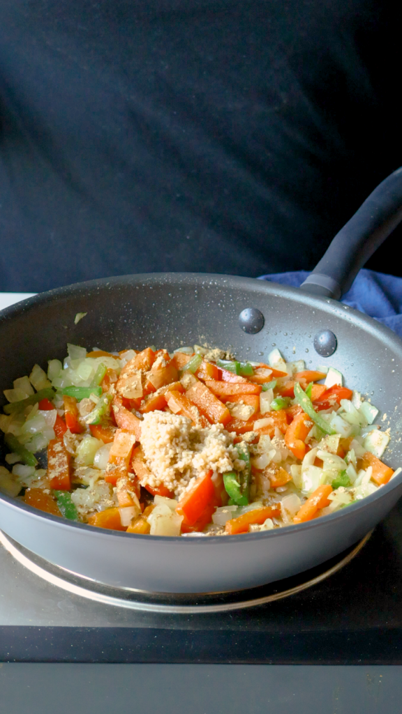 Add ginger and garlic and cook until fragrant, then stir in garam masala, cumin, turmeric and salt.